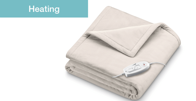 White folded electric heating blanket with control panel for warmth in winter
